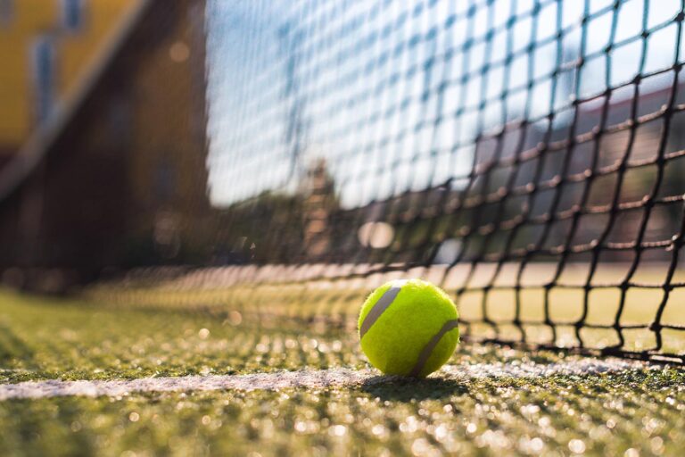 Close Up of tennis ball on white line