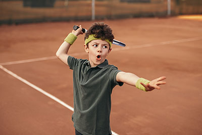 Boy playing tennis