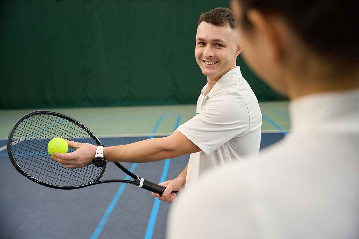 man-trainer-and-woman-working-on-serving-skills